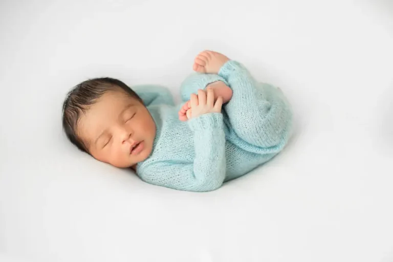 little infant newborn laying little white chair blue crocheted pijamas 2